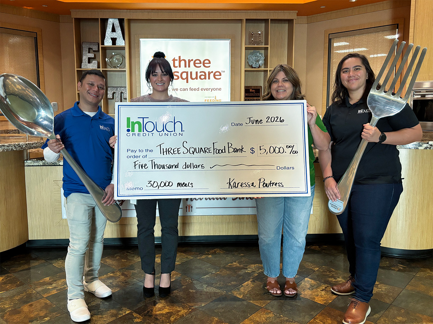 InTouch Nevada Donation InTouch Credit Union team with donation check to Las Vegas area food bank