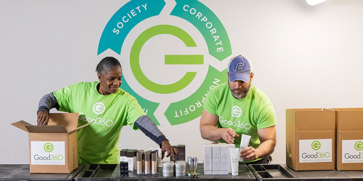 Two Volunteers Filling Boxes for Good360