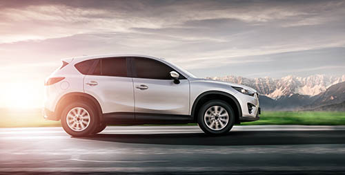 New SUV on open road, symbolizing new car financing from ITCU