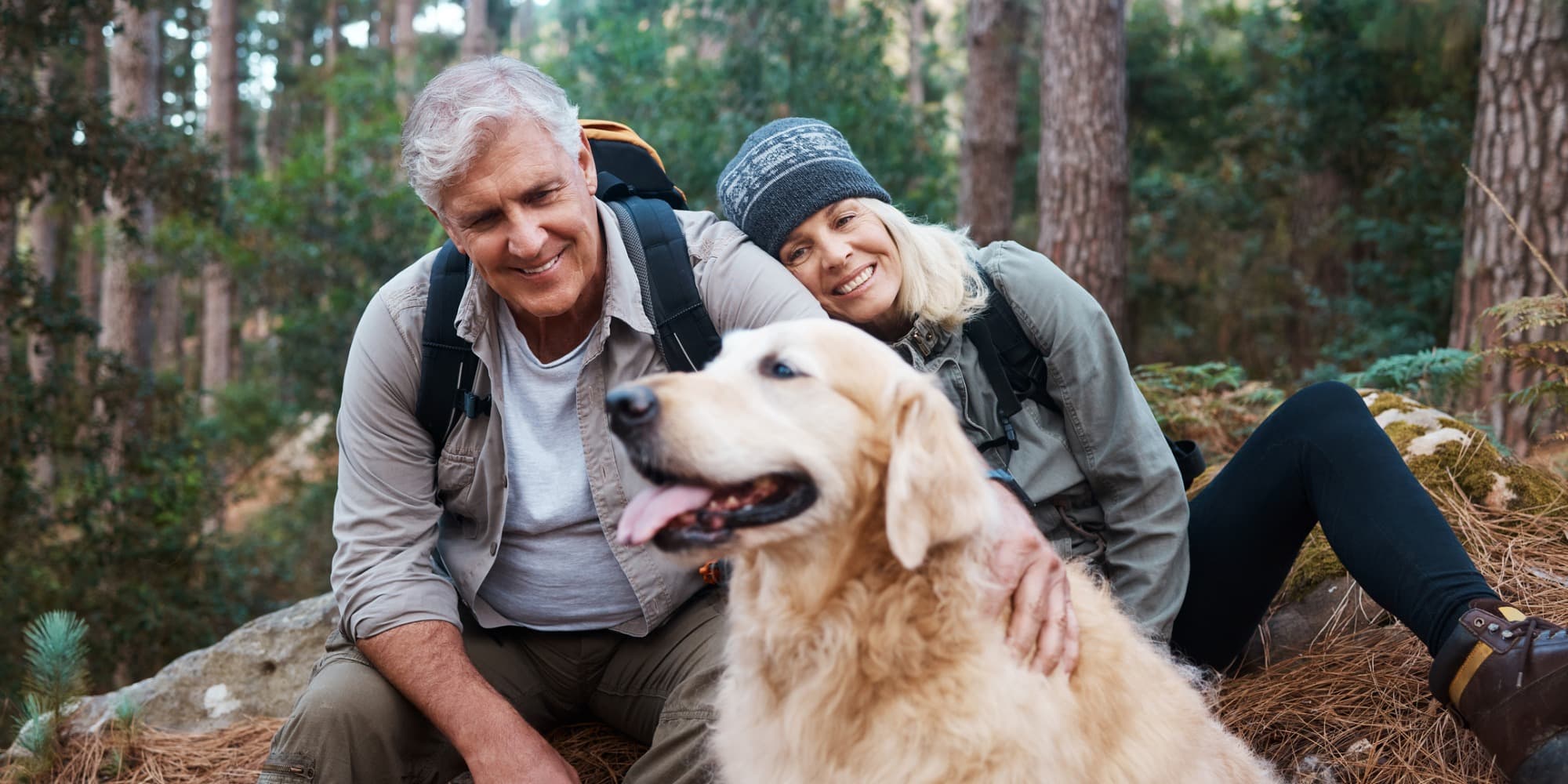 Senior couple hiking with dog