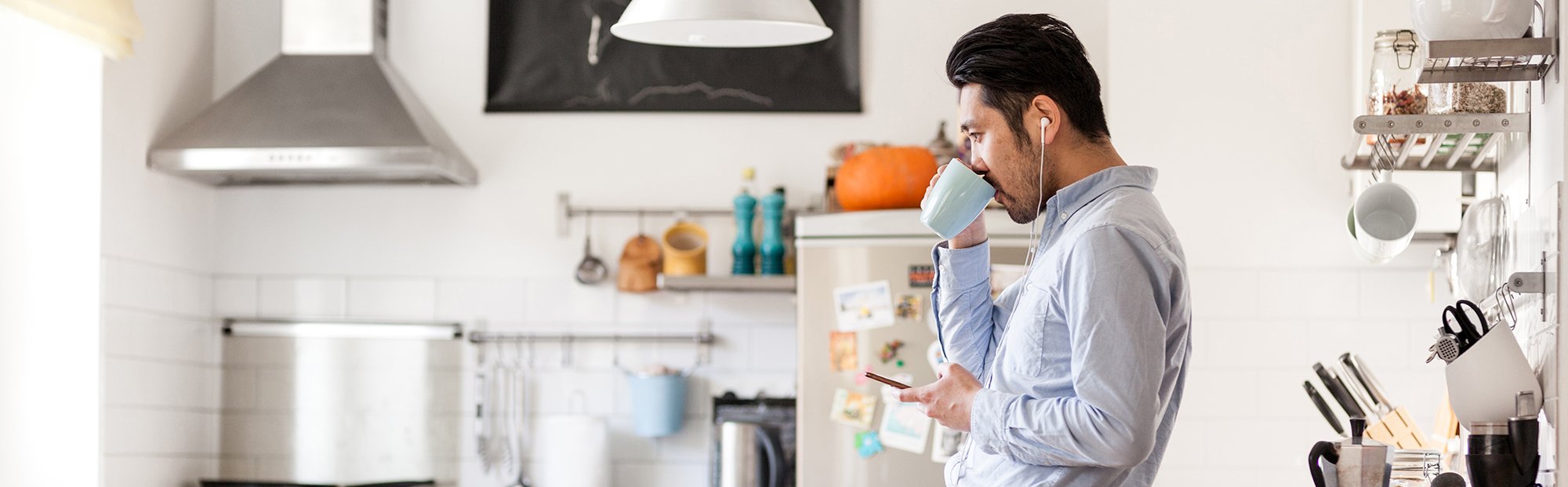 Man with coffee in kitchen