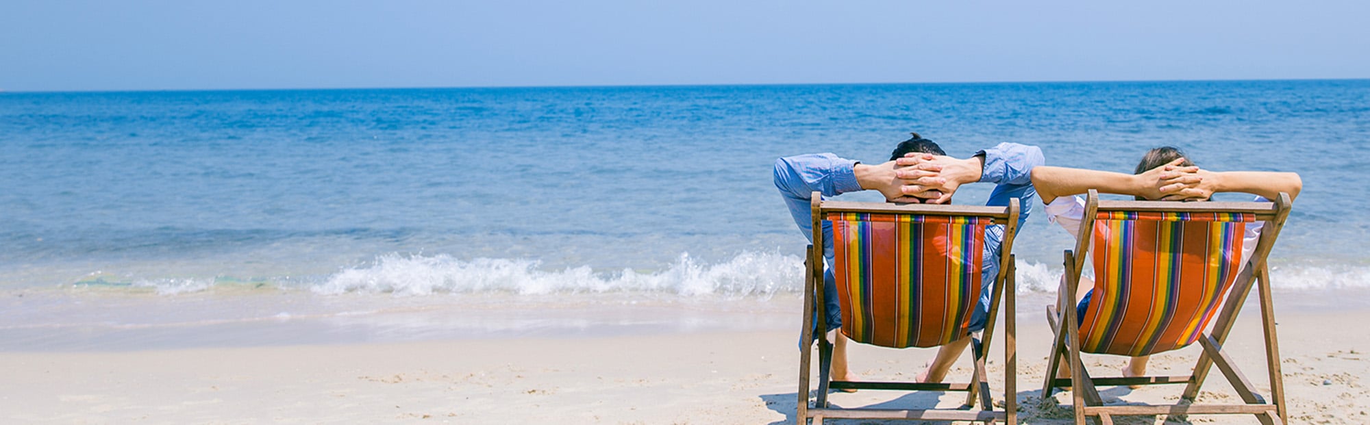 Two Beach Chairs Facing the Coast on Sunny Day