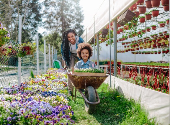 Mother and Daugther Gardening on Sunny Day