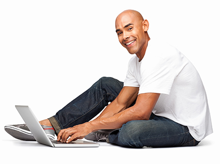Man Sitting, Smiling and Using Laptop