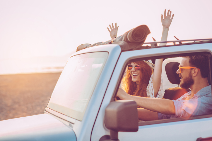 Man and Woman in Jeep at Sunset