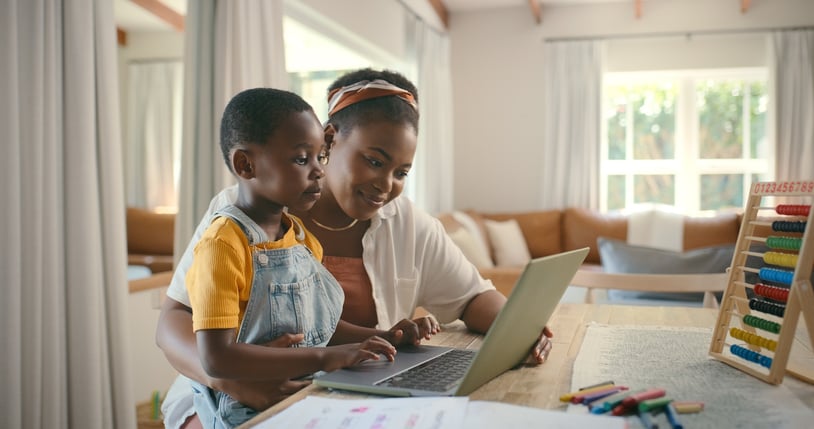 Mother and Son Using Laptop on Sunny Day